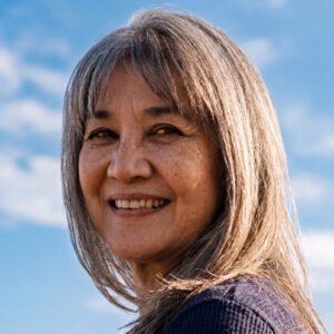 Senior-aged woman with shoulder length hair and bangs