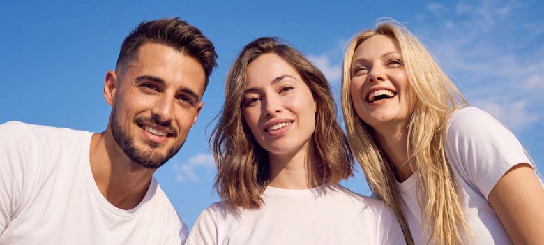 Man standing next to two women