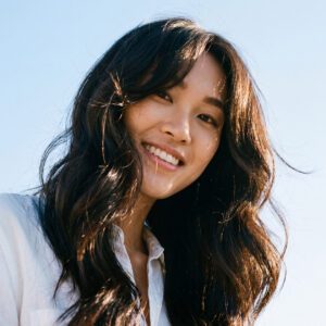 Smiling woman with curtain cut hairstyle and curtain bangs