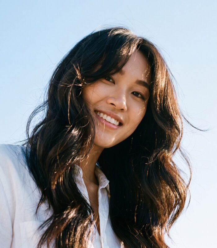 Smiling woman with curtain cut hairstyle and curtain bangs
